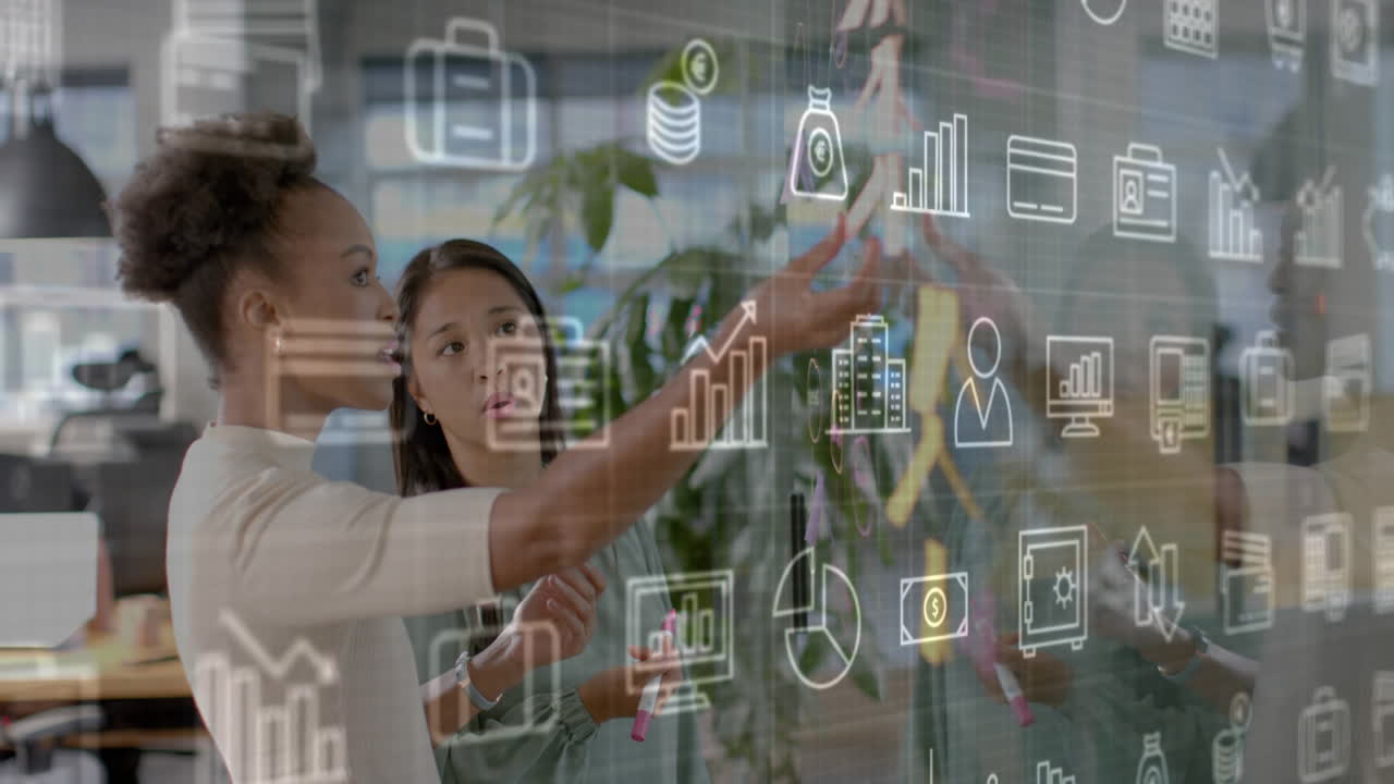 Animation of business media logos over diverse female colleagues brainstorming at casual office