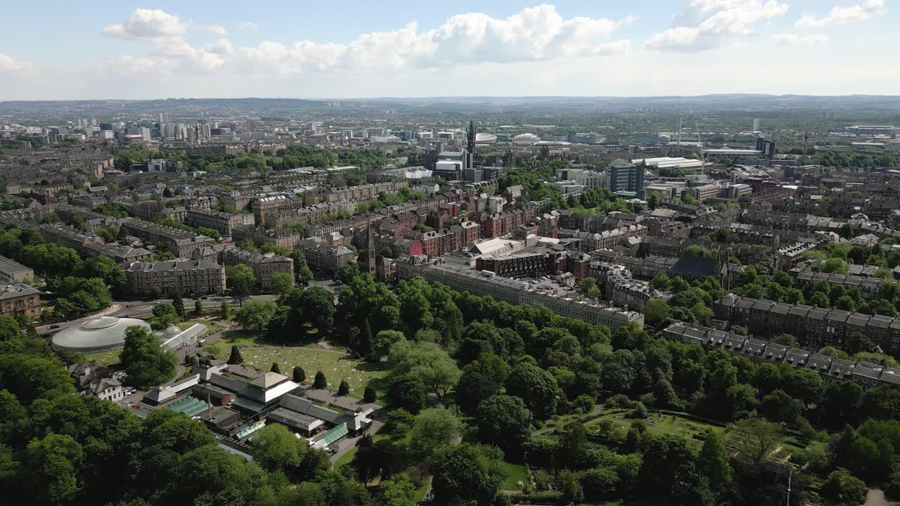 Aerial right panning movement to left track of Kibble Palace and Glasgow Botanic Gardens, Glasgow, Scotland, UK