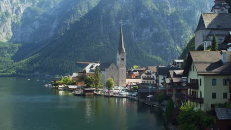 Establishing-shot-of-picturesque-town-of-Hallstatt-in-Austria-with-tower-church