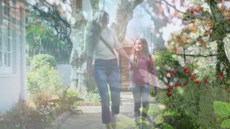 composite video of tall tress against caucasian mother and daughter holding hands walking together