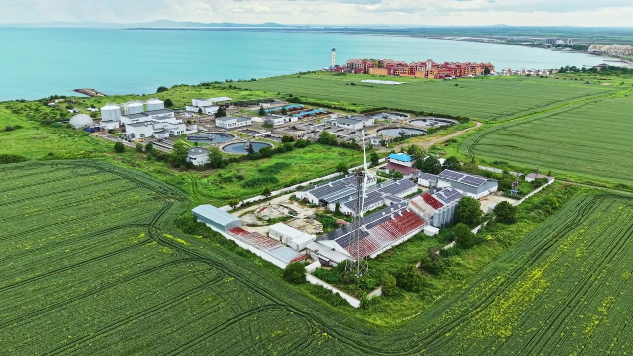 Picturesque scenery of land and sea. Serene coastal village surrounded by fields and azure sky. Charmingly scenic rural area with ocean views and agricultural landscapes