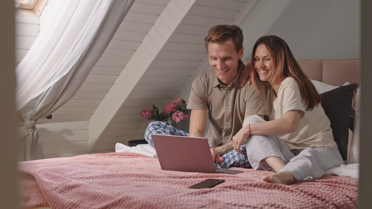 Couple Using Laptop in Morning