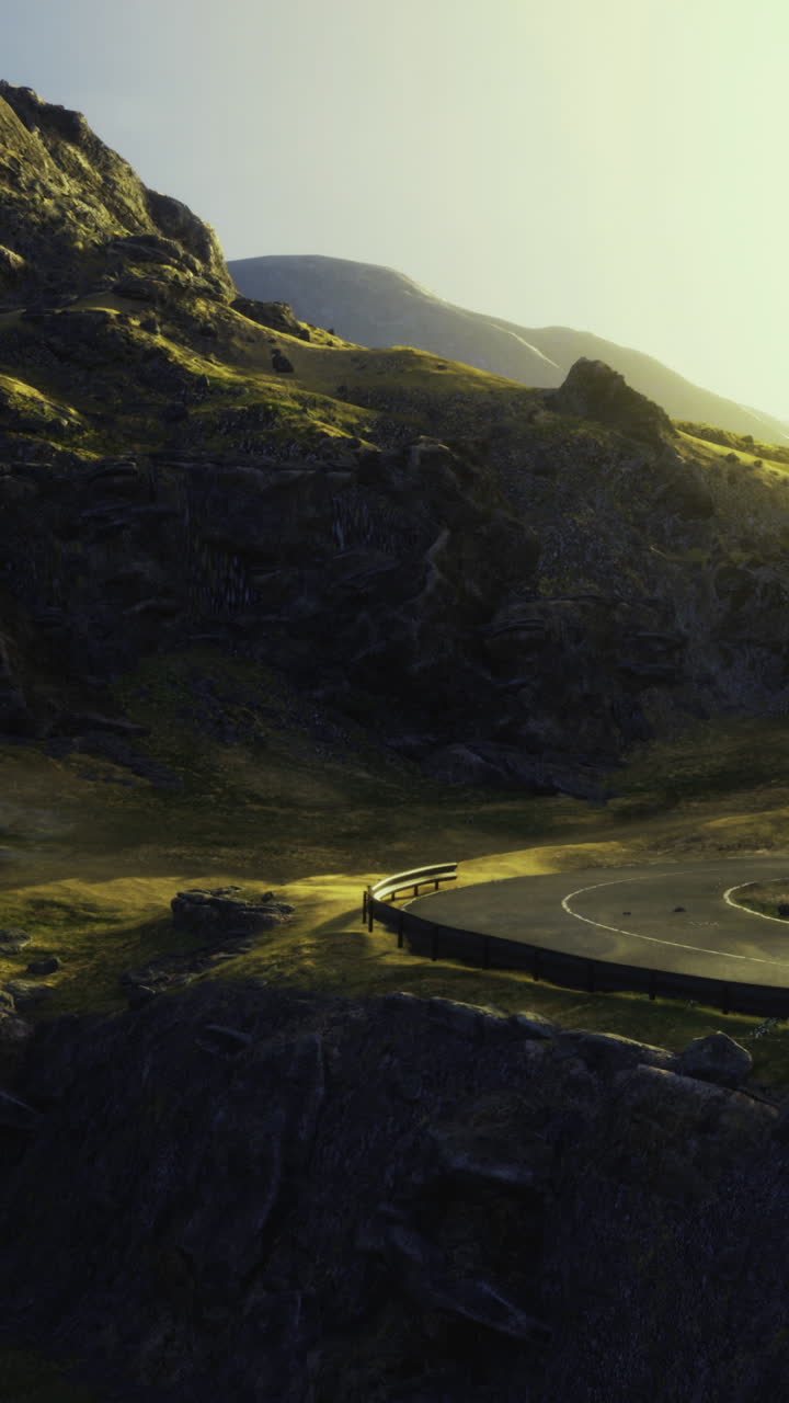 Road curves through rocky terrain under sunlight at scenic location