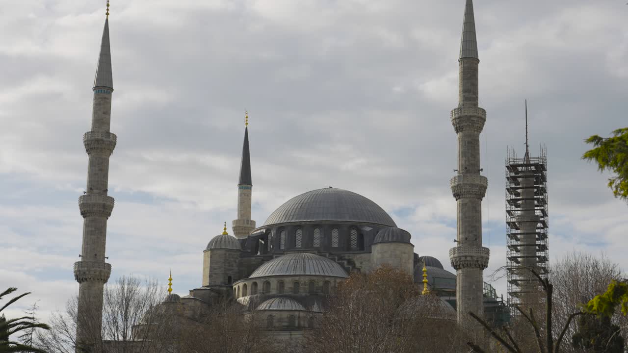 Facade of Blue Mosque in Istanbul. Action. Fabulous architecture of Turkish Mosque. Ancient mosque surrounded by gardens on background of cloudy sky. Architectural sights of Istanbul