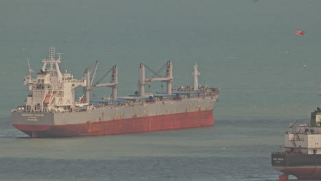 singapore - 5 march 2025 : container ships waiting in the sea by singapore