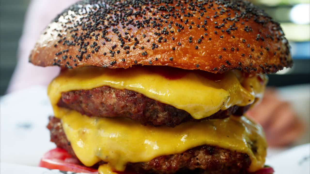 Close up of a big hamburger on a table at a restaurant