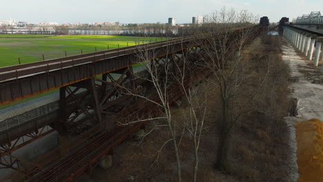 Rusty railroad bridge overgrown with trees in West Memphis Delta Regional River Park