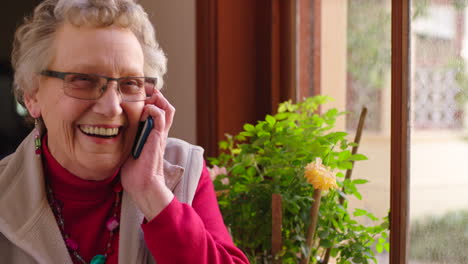 Senior-woman,-phone-call-and-laughing
