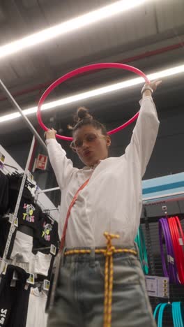 woman practicing hooping in a store