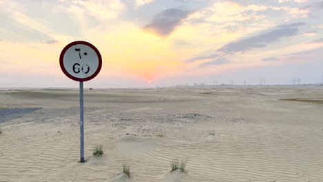 60 km speed limit road sign in the middle of the arabian desert at sunset