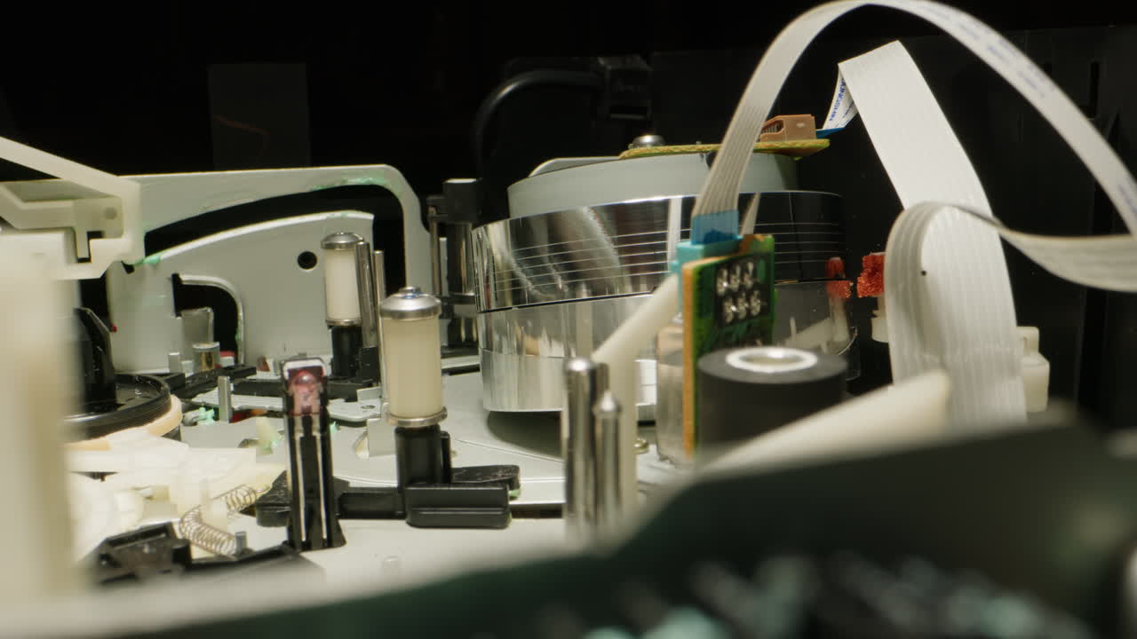 Old video recorder inside close-up, VHS. Retro player in neon blue light, vintage video cassette broadcasting, audio tape.