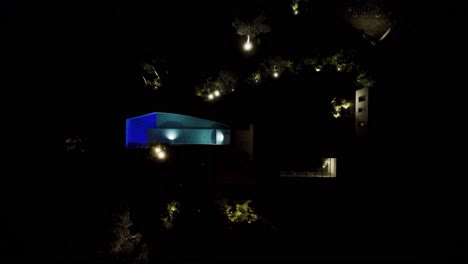 aerial view of a modern house with pool at night