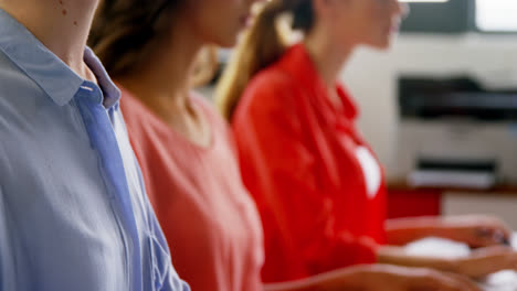 Business-executives-working-on-computer-at-desk