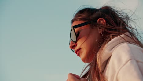 slow motion shot of woman bending down under blue sky