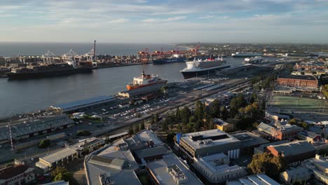 Docked-ships-at-the-harbor,-dynamic-aerial