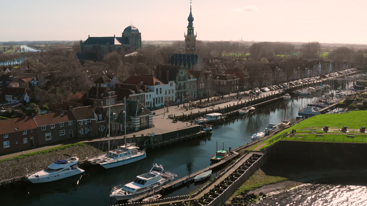 Aerial view of a city with a marina and historical buildings