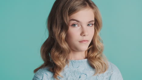 Teenage Caucasian girl raising eyebrow at the camera.