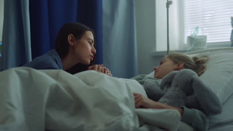 mother visit daughter ward holding hand. supportive parent comforting sick kid