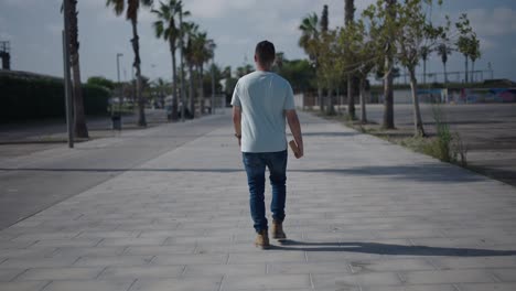 man walking down a city path