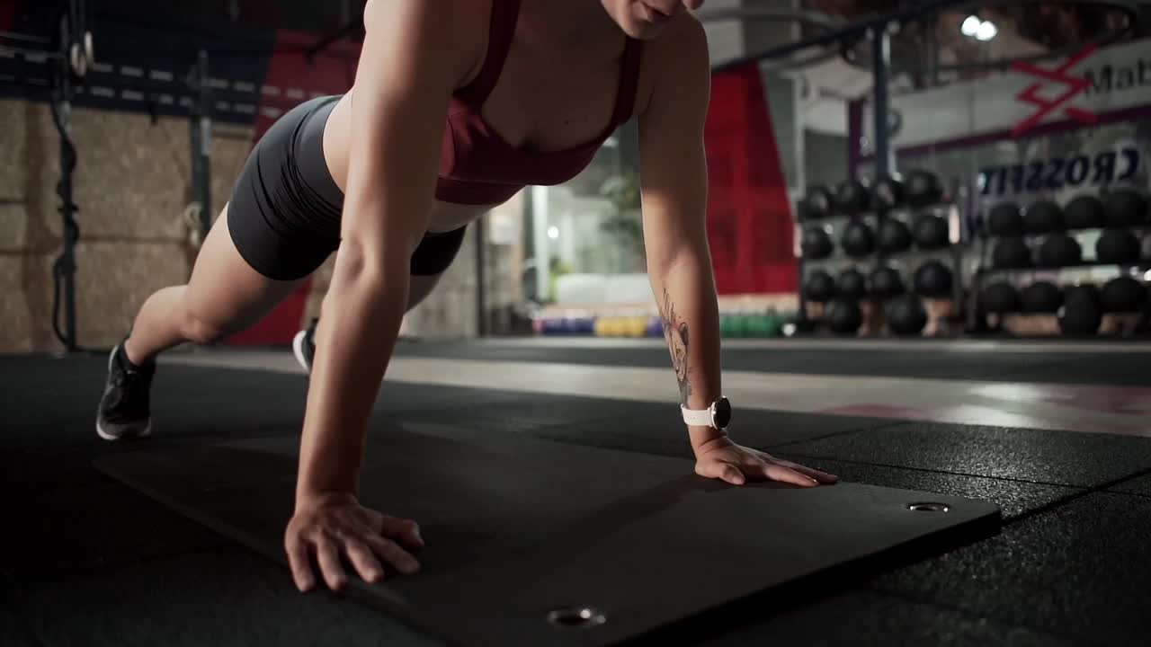 Woman Doing Push-ups in Gym