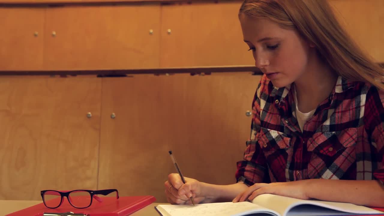 Student taking down notes in class