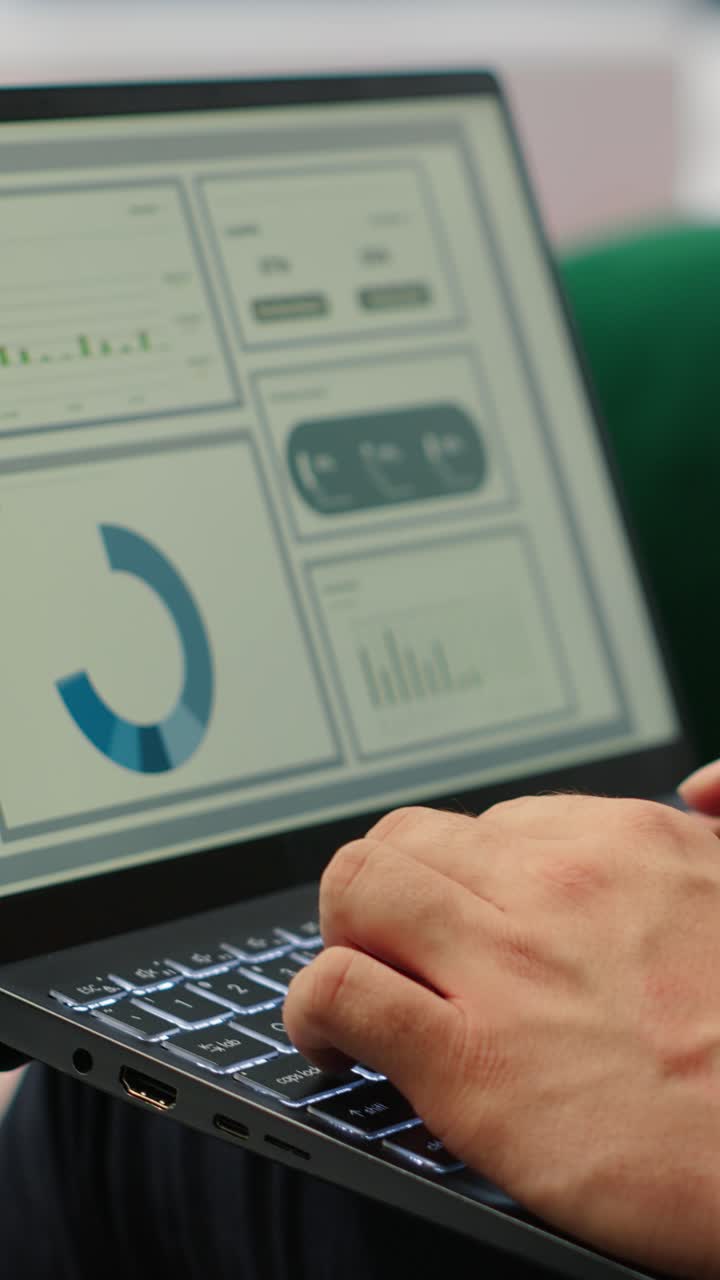 Vertical Video Confident leader reviews sales trends and budget reports in his smart office