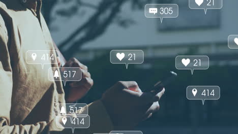 animation of icons and data processing over african american man using smartphone