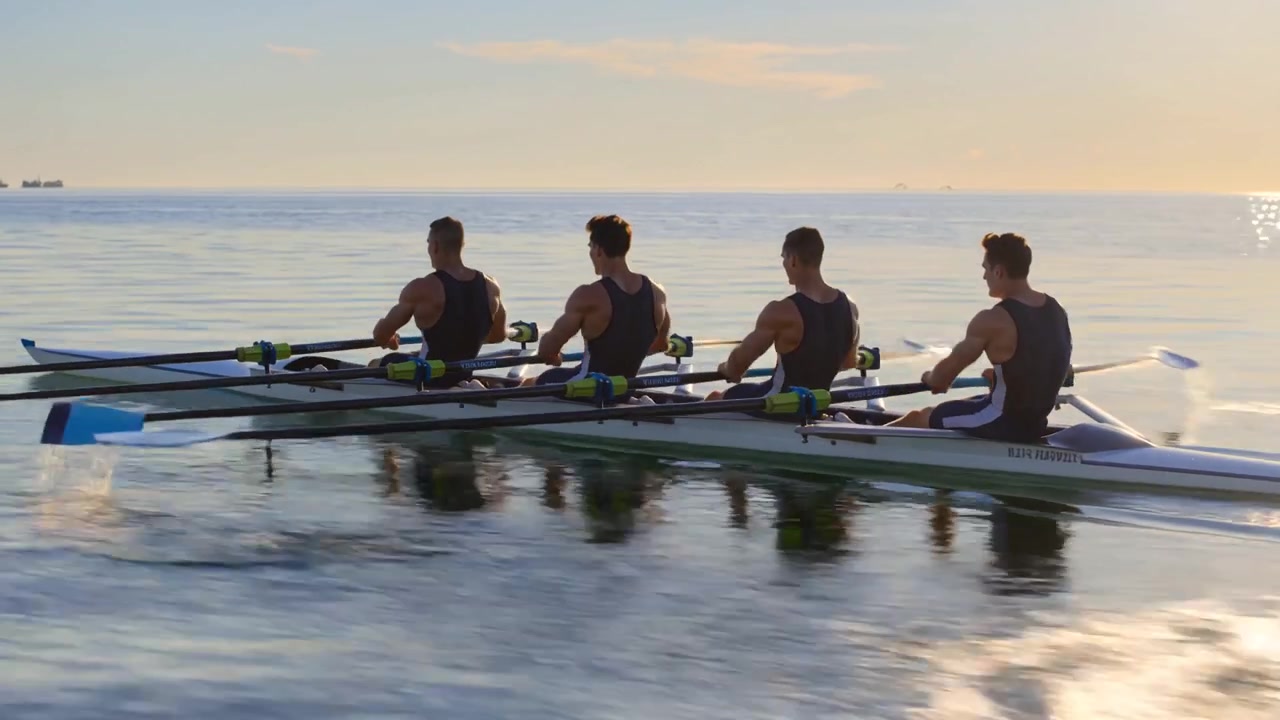 Four Men Rowing a Quad Scull on Calm Ocean Water at Sunrise