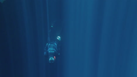 Underwater shot from Free diving into cave, clear water and gorgeous sun-rays entering from top. Slow motion 120fps
