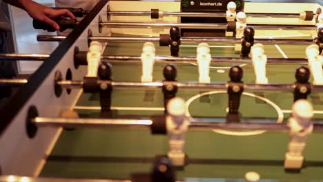 players engaged in a foosball match