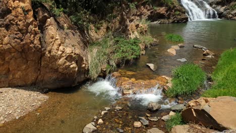 Crocodile-river-waterfall-flowing-and-falling-over-rocks-at-the-walter-sisulu-national-botanical-gardens-in-roodepoort,-South-Africa