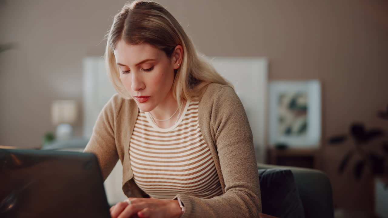 A young woman working on a laptop at home