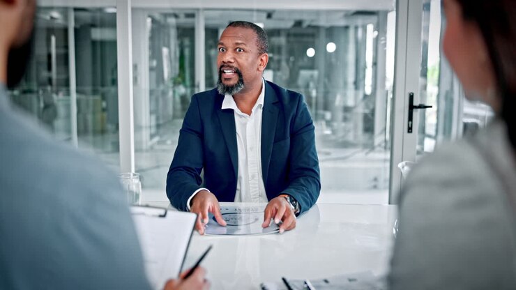 Professional Businessman Talking and Gesturing During a Meeting