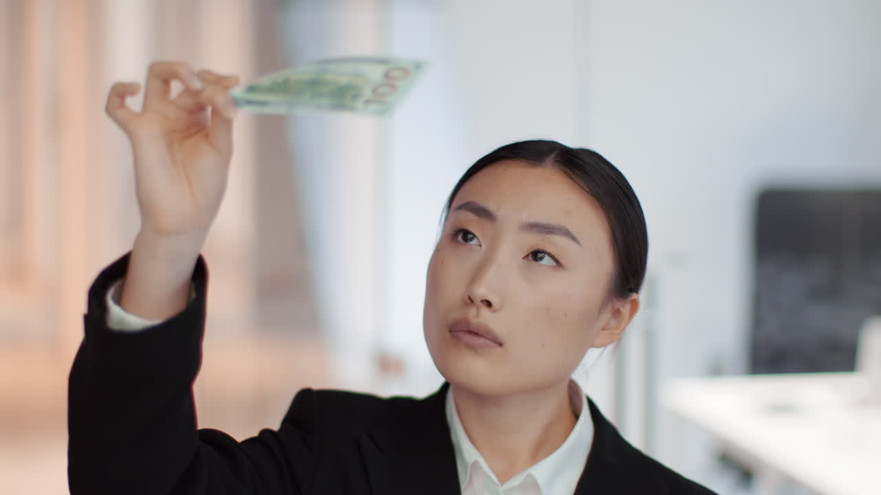 Businesswoman Looking at Money