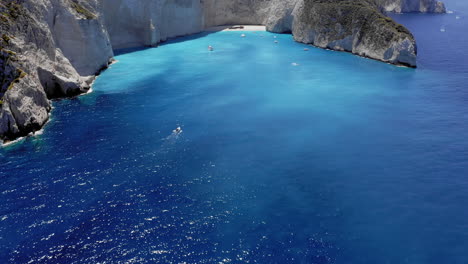 Aerial:-Reveal-shot-of-navagio-bay-and-ship-wreck-beach-in-summer