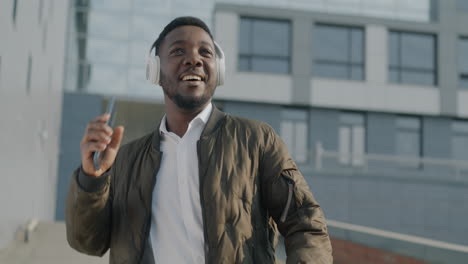 happy man dancing in the city