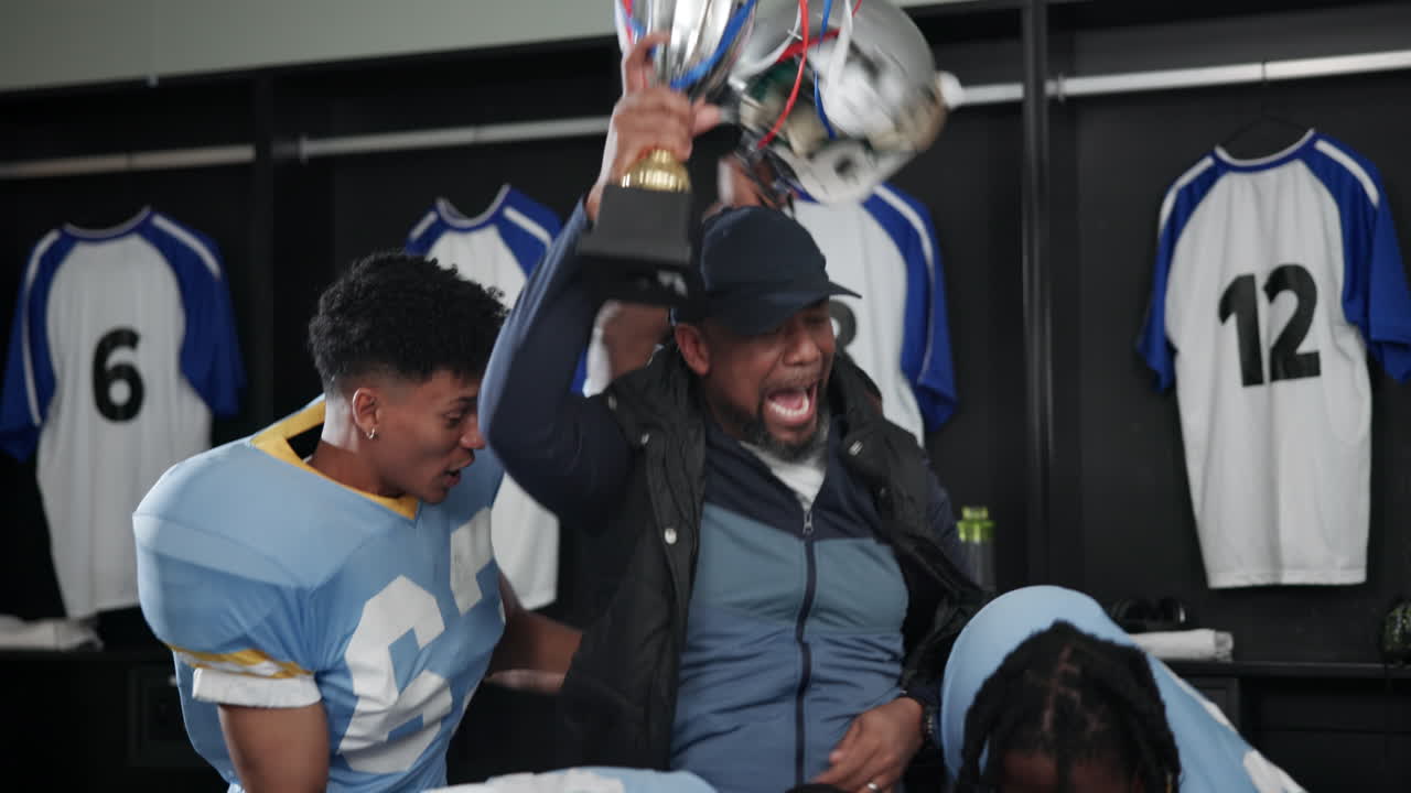 Football team celebrating victory in locker room