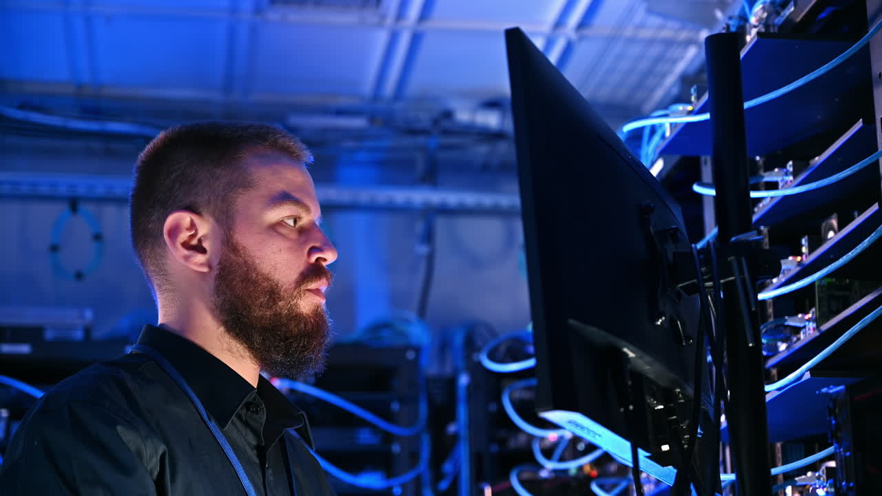 Man programming in a server room