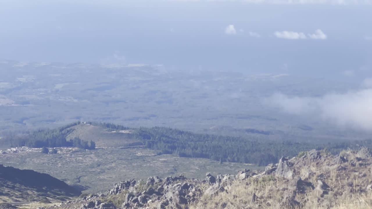 Cinematic wide panning shot overlooking the Maui upcountry from the slopes of Haleakala in Maui, Hawai'i