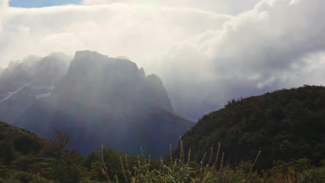 static video showing vast patagonian mountains, rugged peaks, and moving clouds over an open valley with dramatic light on a windy day