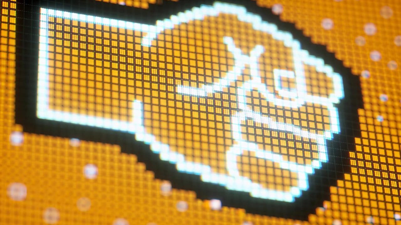 La telecamera si sposta, rivelando una mano pixelata delineata di bianco su una griglia LED arancione, esponendo i dettagli dei subpixel.