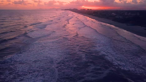 establishing 4k drone shot showing beautiful beach and palms in sunrise in brazil