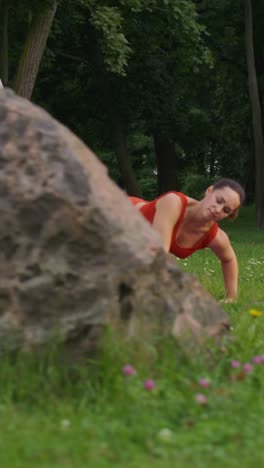 woman practicing yoga in a park