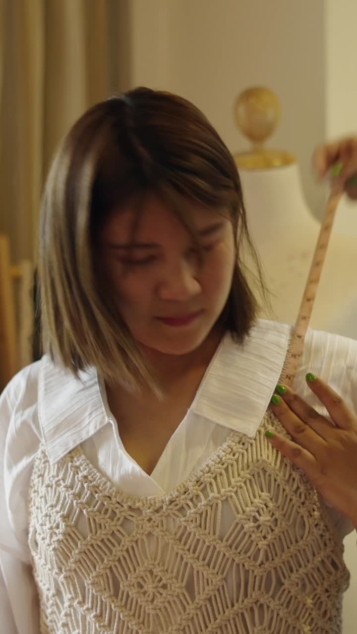 Woman taking measurements for clothing