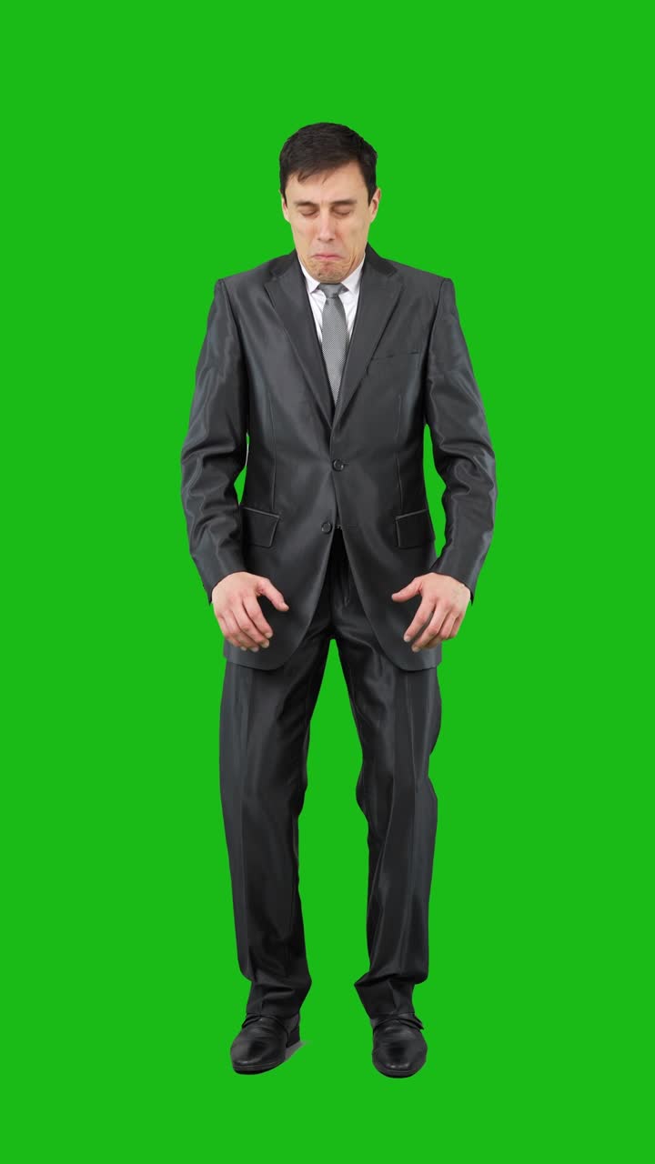 Man in a suit displaying various facial expressions on a green screen