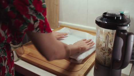 woman puts wax paper on baking pan