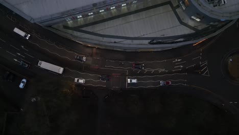 static aerial view tracking vehicles on busy roads near a commercial building in redhill.