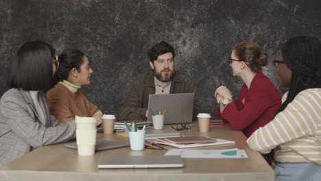 multiethnic colleagues having conference at table
