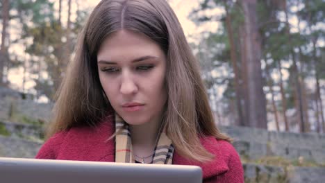 woman working outdoors on a laptop