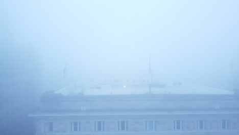 ghostly dense city fog aerial dolly right view across chilling downtown magical skyline